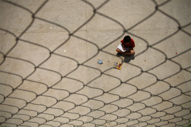 César dibuja bajo el sol en la cancha de la urbanización La Trinidad, Ilopango. Foto Mauro Arias